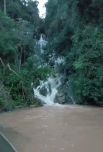 a waterfall in the middle of a forest at Rancho do Pijuca in Ortigueira
