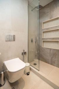 a bathroom with a toilet and a shower at Cozy Spot II near the beach in Ayiá +13 photos