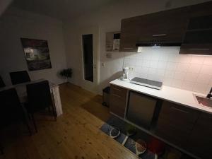 a kitchen with a white counter top and a room at Brix Apartment in Naumburg