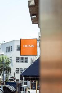 an orange sign with the word berms on a building at BENS - Recoleta Park in Buenos Aires