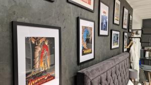 eine Wand mit gerahmten Filmplakaten darauf in der Unterkunft Victoria Loft in Bowness-on-Windermere + 33 Fotos