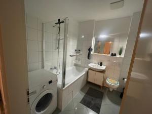 a bathroom with a shower toilet and a sink at Brix Apartment in Naumburg