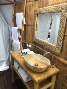 a bathroom with a wooden sink and a mirror at URQU Glamping cerca a Bogota in Silvania