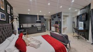 a bedroom with a large bed and a kitchen at Victoria Loft in Bowness-on-Windermere