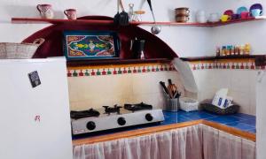 a kitchen with a stove top in a kitchen at Casa Azul in Chefchaouene