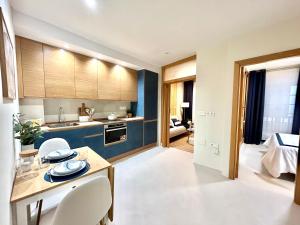a kitchen and living room with a table and chairs at CAMBARAL AS DE GUIA in Luarca +28 photos