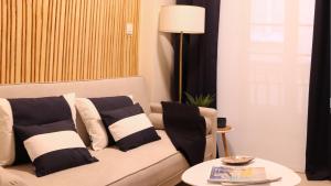un soggiorno con divano, cuscini e tavolo di CAMBARAL AS DE GUIA a Luarca
