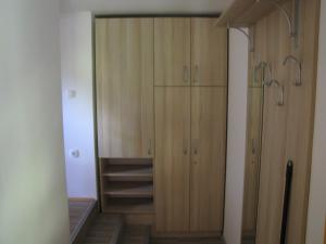 a closet with wooden cabinets in a room at Apartma Zo-Vi Bled in Bled