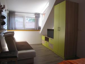 a living room with a green cabinet and a tv at Apartma Zo-Vi Bled in Bled