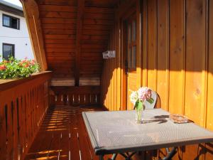 a table with a vase of flowers on a deck at Apartma Zo-Vi Bled in Bled