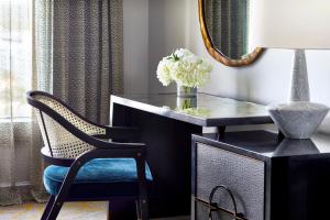 a black desk with a chair and a mirror at Grand Bohemian Hotel Orlando, Autograph Collection in Orlando