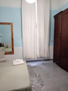 a bedroom with a mirror and a bed and a dresser at Piazza Verdi Liberty House in Lecce