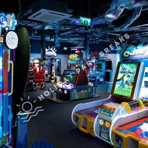 a room with many arcade games and video games at Sunset - A Relaxing Gold 3 bed holiday home at Seal Bay Resort in Chichester