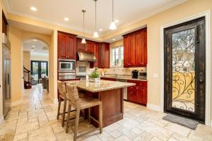 a kitchen with a large island with a table and chairs at Luxury Beach House Rooftop Deck in Huntington Beach