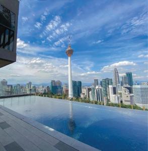 a large swimming pool with a view of a city at Infinity Pool Ceylonz Suites KLCC in Kuala Lumpur