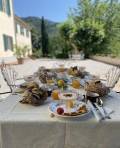 una mesa con platos de comida y bebidas. en Tenuta di Tramonte Boutique Hotel, en Lucca