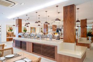 a restaurant with a counter and a dining room at Beach Park Resort - Wellness in Aquiraz