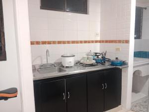 a kitchen with a sink and a counter top at PARTAMENTO VALLEDUPAR in Valledupar