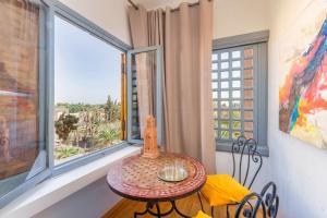 a small table in a room with a large window at Moroccan typical flat, Hivernage in Marrakesh