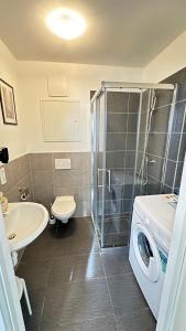 a bathroom with a sink and a washing machine at Private Studio mit eigene Küche und Bad Netflix Youtube in Nuremberg