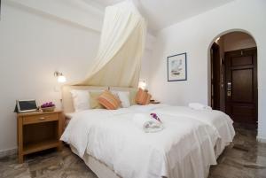 a bedroom with a white bed with a canopy at Zephyros in Paraga +37 photos