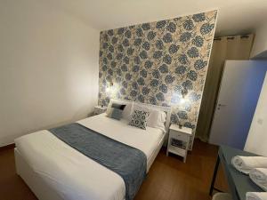 a small bedroom with a bed and a wall at Charming Canonica Apartments in Milan