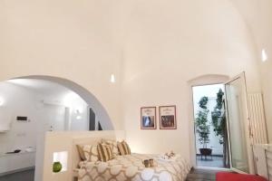 ein weißes Schlafzimmer mit einem Bett und einem großen Fenster in der Unterkunft Bienvenue à Bari! in Bari