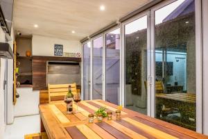 a dining room with a wooden table on a balcony at Sea Salt - Lampiesbaai in St. Helena Bay