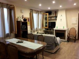 a living room with a couch and a table at Cosy Chalet in L'Arboçar with Private Pool, 65 sqm in Barcelona