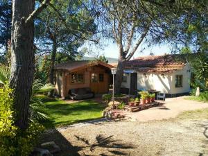 a small house with a porch and a yard at Cosy Chalet in L'Arboçar with Private Pool, 65 sqm in Barcelona