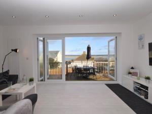 a living room with a large window and a table at 4 Bed in Appledore 55573 in Appledore