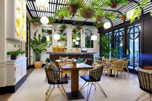 a restaurant with a table and chairs and plants at Amazing VIP Apartment BENTAYGA in Baku