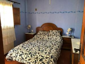 una camera da letto con un letto con un piumone bianco e nero di 5 bedrooms chalet with terrace and wifi at Altura ad Altura