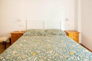 a bedroom with a bed and two dressers and a bedspread at One bedroom appartement with wifi at Baiona in Baiona