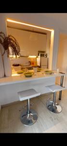 a kitchen with a counter and two stools in it at Maria Louiza apartment NEAR CENTER in Athens