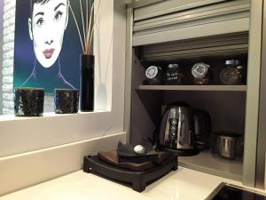 a kitchen with a coffee maker and a picture of a woman at One bedroom property with wifi at Zaragoza in Zaragoza