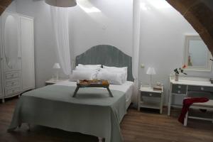 a bedroom with a bed with a table on it at One bedroom villa at Chania 800 m away from the beach with wifi in Kolymvari