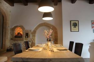 a dining table with chairs and a light fixture at One bedroom villa at Chania 800 m away from the beach with wifi in Kolymvari