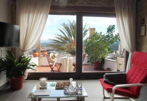 a living room with a large window looking out onto a patio at One bedroom villa at Chania 800 m away from the beach with wifi in Kolymvari
