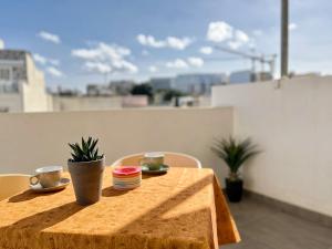 a table with two cups and plates on top at Marina Apartments in Msida