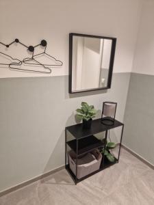 a table with a mirror and a shelf with plants at FeWo Mösle in Lautrach +3 photos