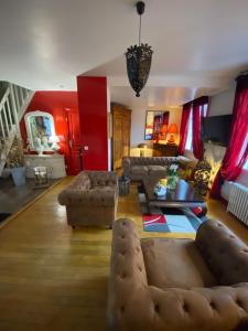 a living room with a couch and a table at Chez Patou in Laval +37 photos
