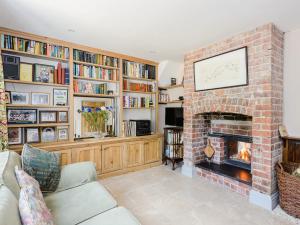 a living room with a brick fireplace and book shelves at 4 Bed in Llanidloes 51651 in Llandinam