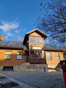 a house with solar panels on top of it at Willa KAMELIA-apartamenty in Krynica Zdrój