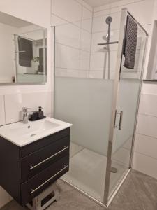 a bathroom with a sink and a shower at FeWo Mösle in Lautrach