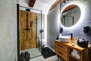a bathroom with a shower and a sink and a mirror at Willa KAMELIA-apartamenty in Krynica Zdrój +63 photos