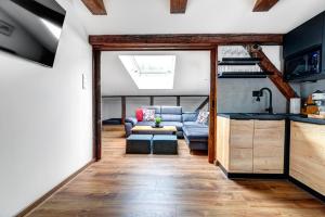 a living room with a couch and a table at Willa KAMELIA-apartamenty in Krynica Zdrój