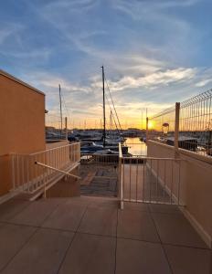 een zonsondergang boven een jachthaven met boten in het water bij studio pour 4 personnes proche du port et des plages in Cap d'Agde