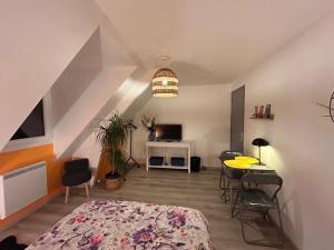 a bedroom with a bed and a table and chairs at Chambre mont saint Michel in Huisnes-sur-Mer