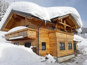 a log cabin covered in snow at Ferienhaus Lechnerhof in Schladming